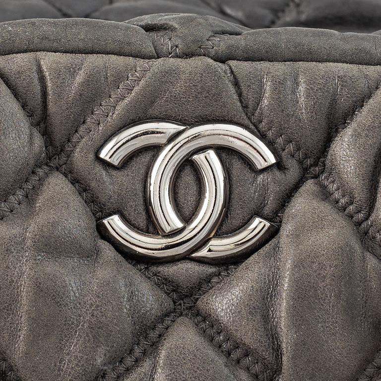 Chanel, a grey leather bag.