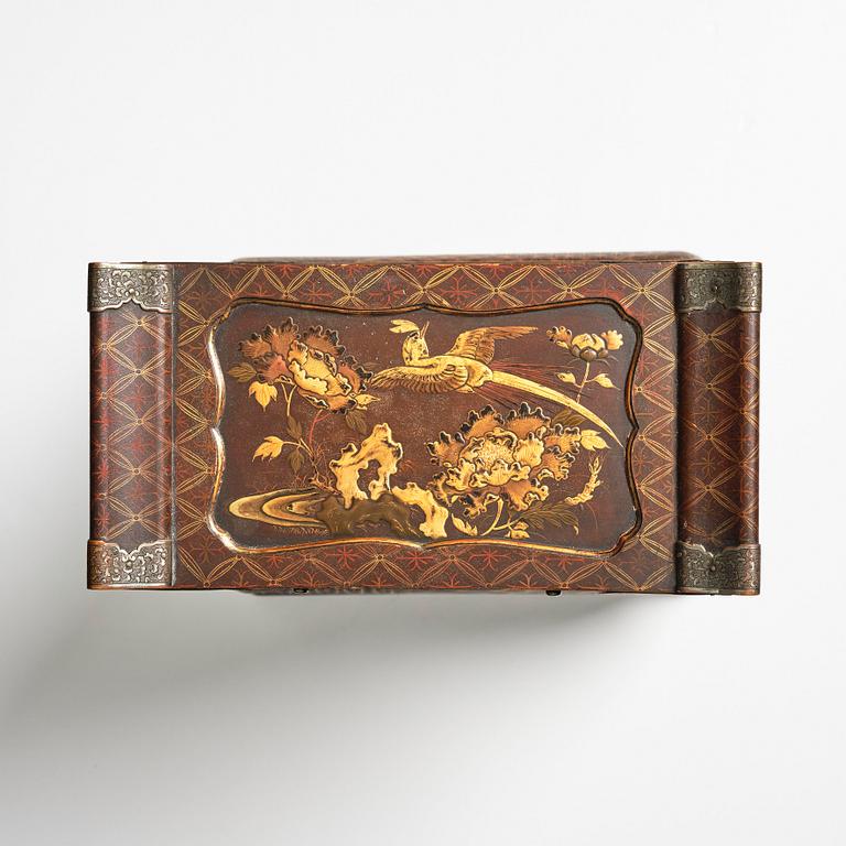 A Japanese lacquer cabinet on a stand, Meiji period (1868-1912).