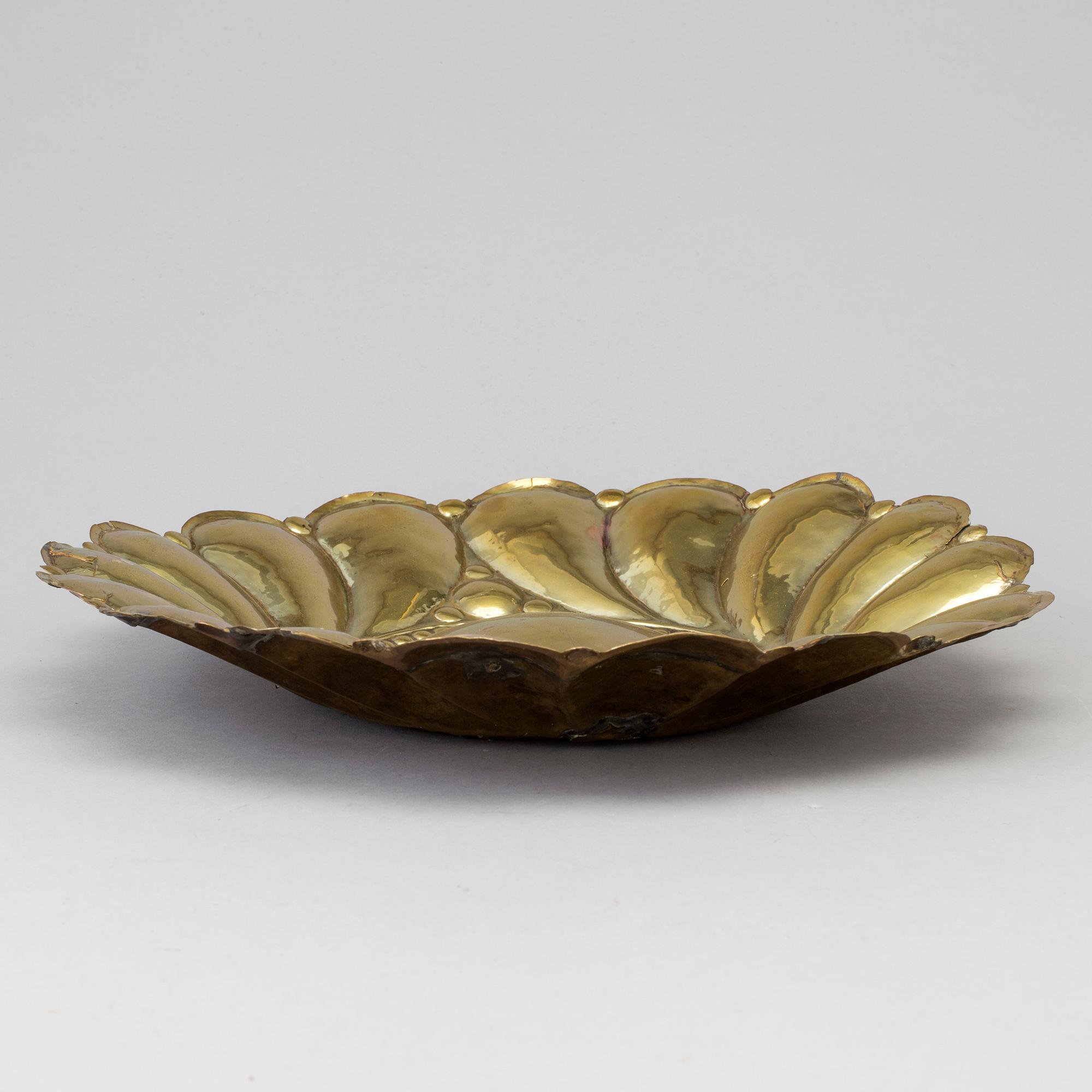 A 17th century brass wall plaque.