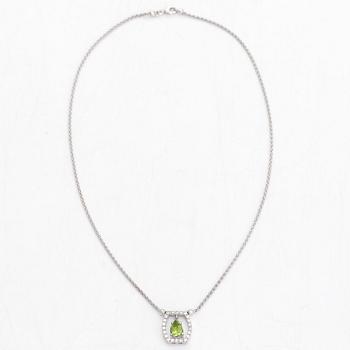 An 18K white gold necklace, with a pear-shaped peridot and diamonds totalling approximately 0.44 ct.