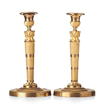 104. A pair of French Empire candlesticks, early 19th century.