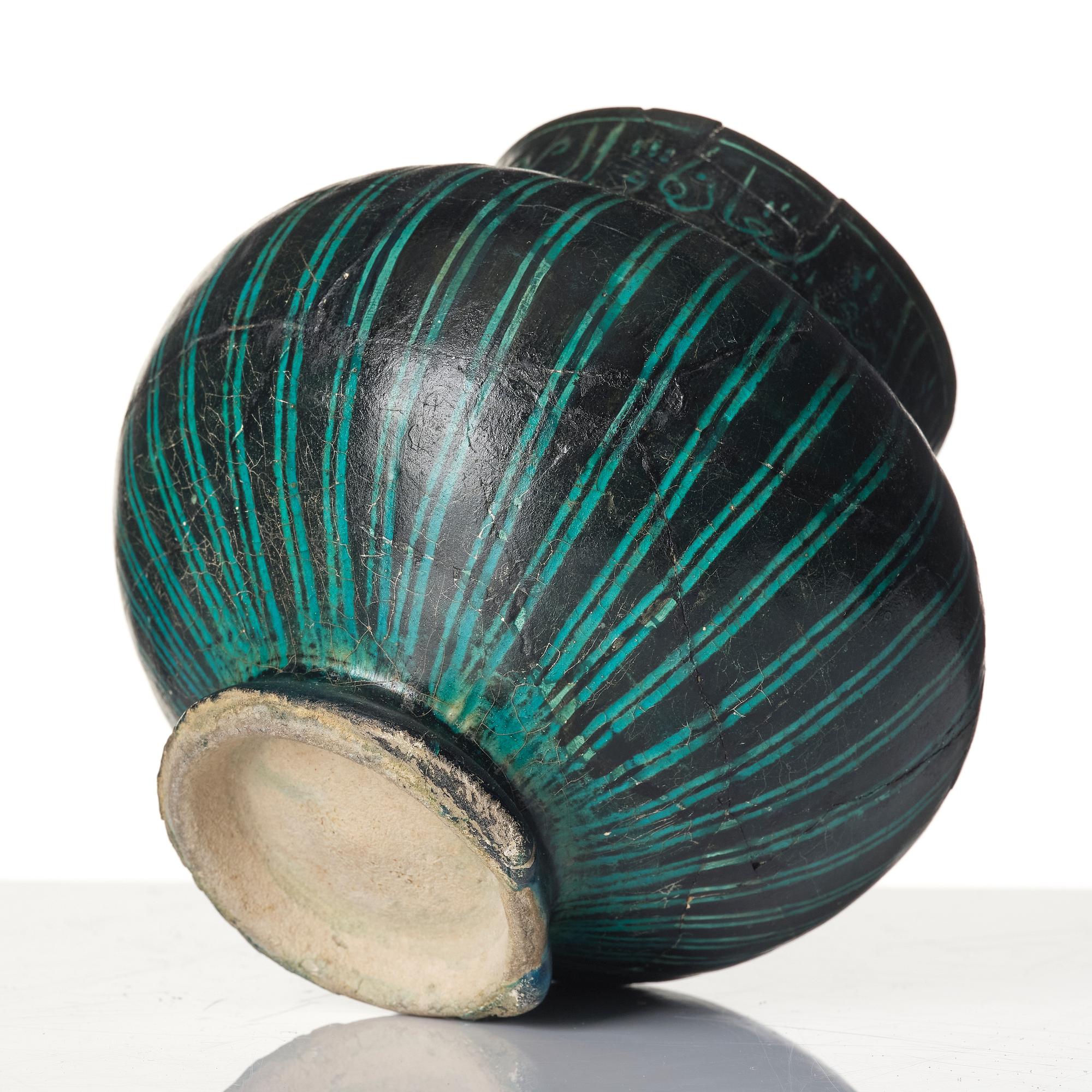 A Kashan Silhouette ware turquoise glazed pottery jug, central Iran, circa 1200.