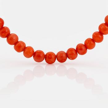 A coral necklace with a 14K gold clasp.