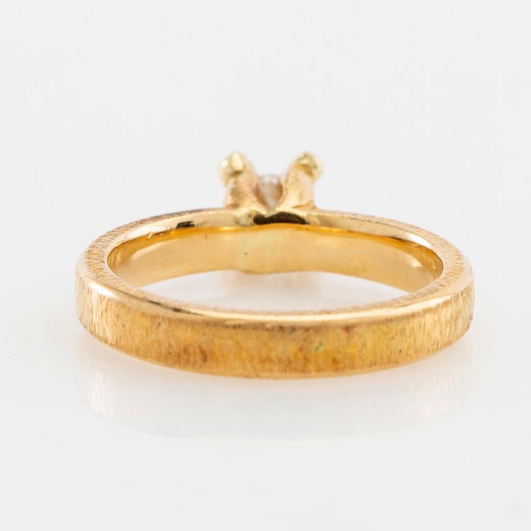 Solitaire ring in 18K gold with a round brilliant-cut diamond.