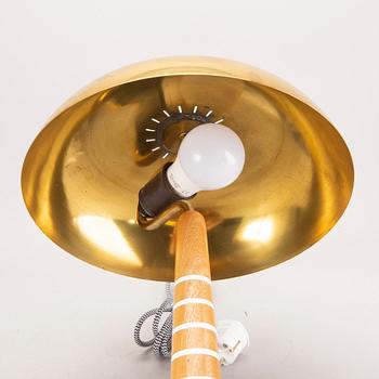 A Swedish Modern 1940s brass and wood lamp.