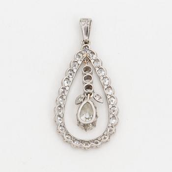 A pendant set with a pear cut diamond surrounded by old cut diamonds.