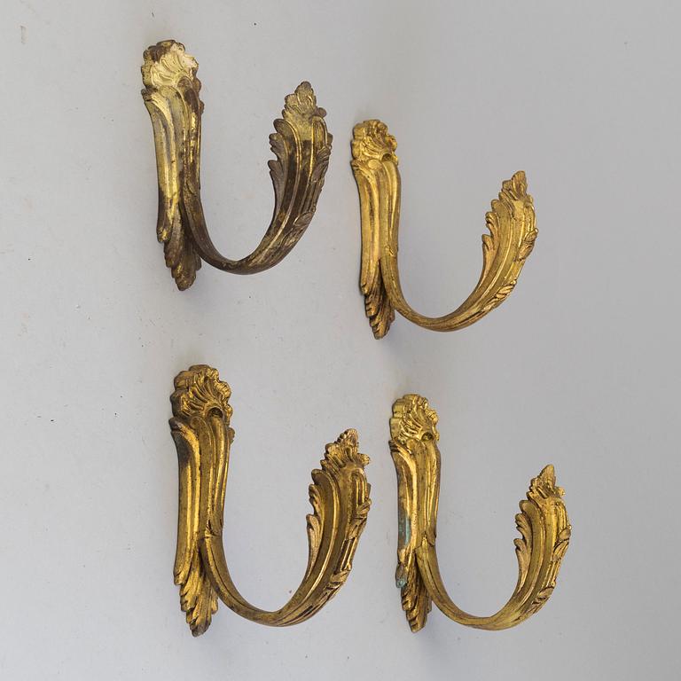 A SET OF FOUR BRONZE CURTAIN TIE-BACKS, 19th century.