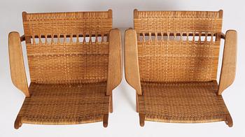 Hans J. Wegner, a pair of oak easy chairs 'CH27', Carl Hansen & Son, Denmark, 1950s.