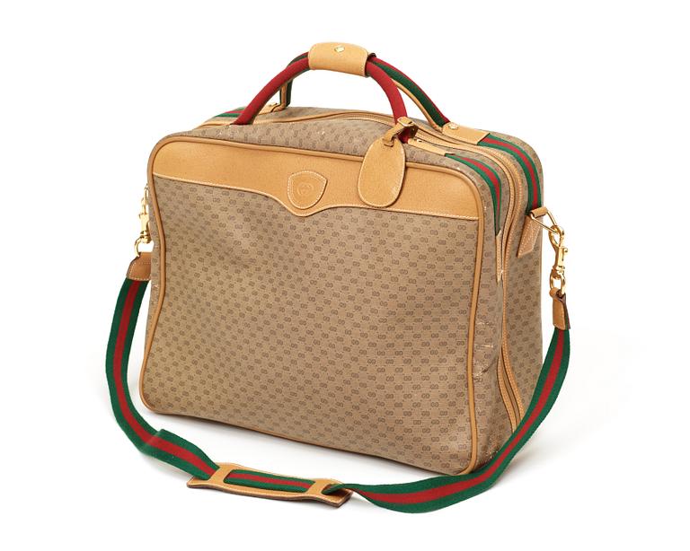 A weekend bag/ travelling bag by Gucci.