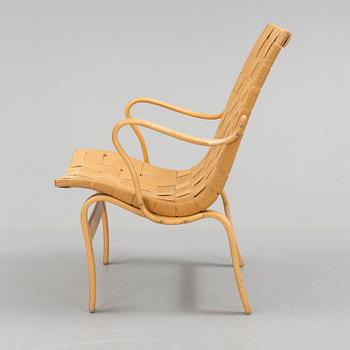 an "Eva" armchair by BRUNO MATHSSON 1963.