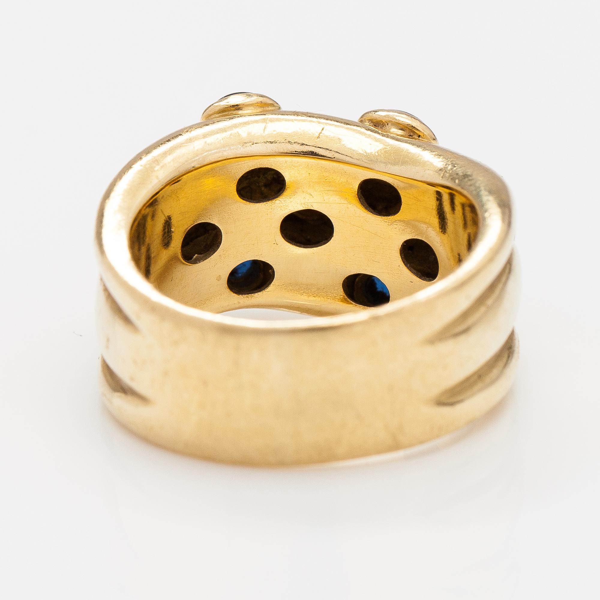 An 18K gold ring with rubies and sapphires. Import marked Torbjörn Tillander, Helsinki 1991.
