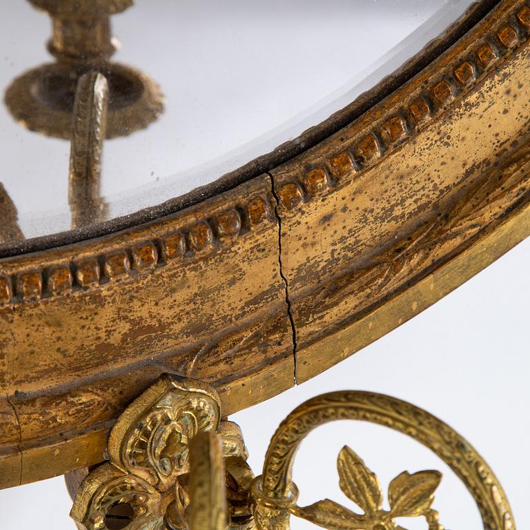 A Gustavian two-light girandole mirror, Stockholm, late 18th century.