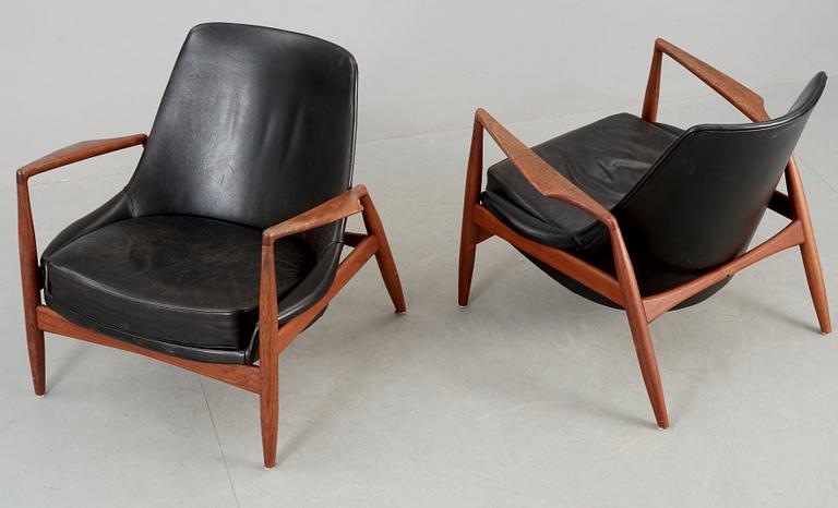 A pair of Ib Kofod Larsen 'Sälen' teak and black leather easy chairs by Olof Person, Jönköping, Sweden.