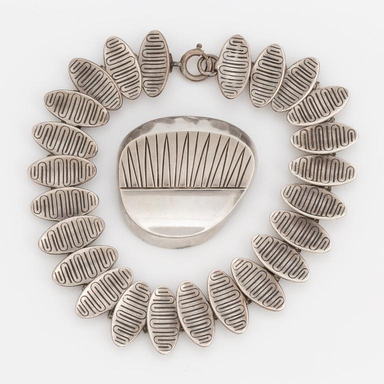 A 1950's silver bracelet and brooch.