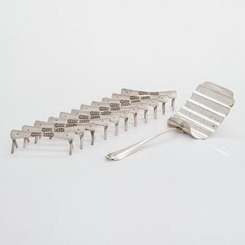 An 11-piece set of Belgian silver knife stands byDelheid Frères, and a silver asparagus server, Bremer Silberwarenfabrik.