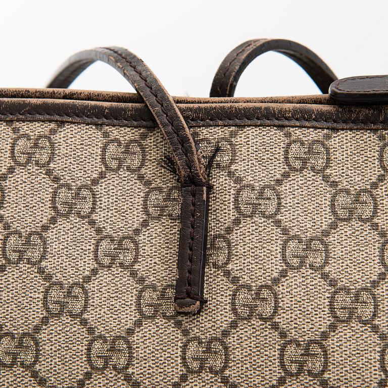 Gucci, a canvas tote bag.