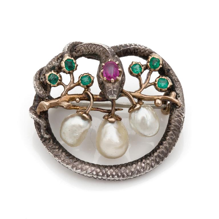 A Karl Rothmüller, Art Nouveau serpent brooch, circa 1900, with a ruby, emeralds and probably natural saltwater pearls.