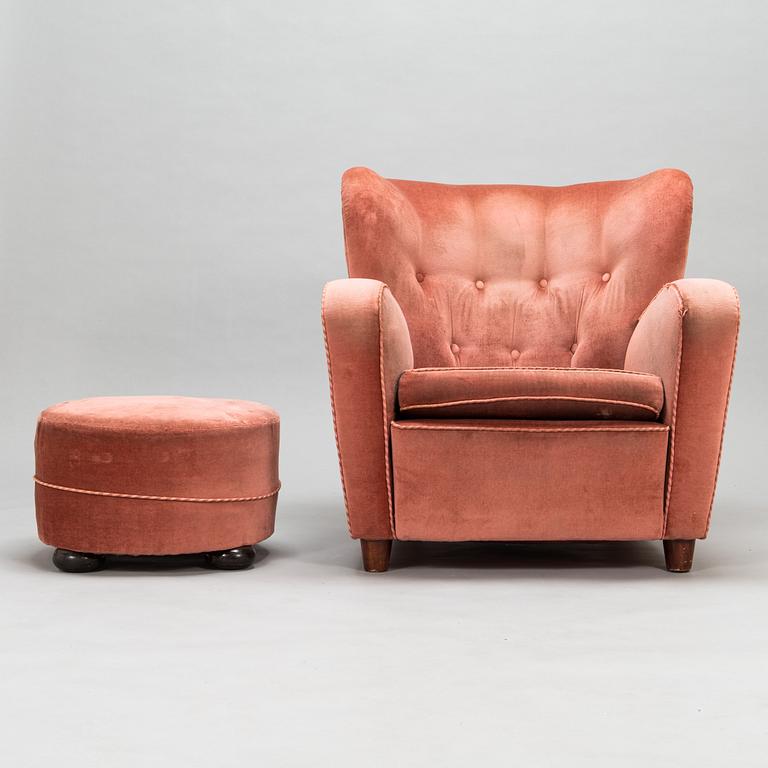 A mid-20th century armchair and ottoman.