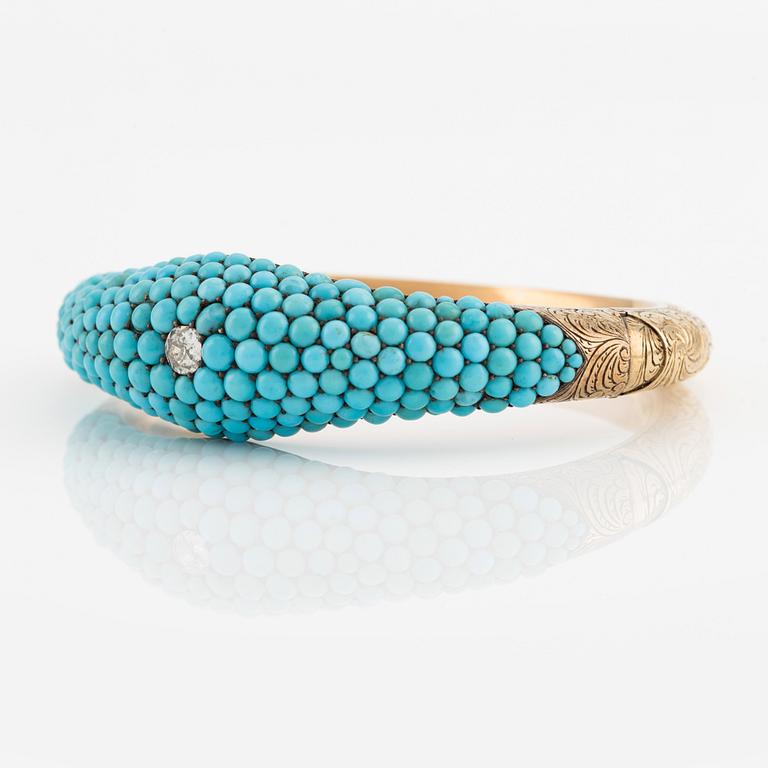 An 18K gold bracelet with turquoises and an old-cut diamond.