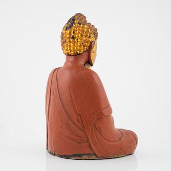 A large Vietnamese gilt and lacquered wooden buddha, circa 1900.