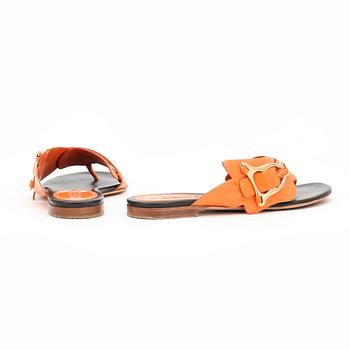 CÉLINE, a pair of orange leather sandals.