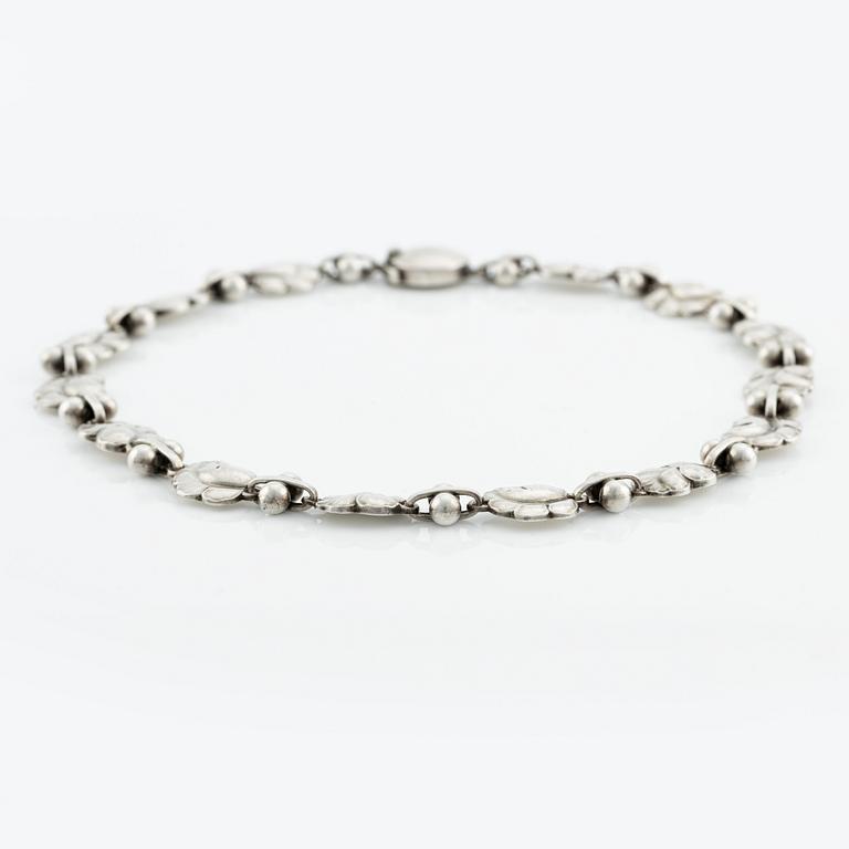 Harald Nielsen, a sterling silver necklace, a brooch, and a pair of earrings, for Georg Jensen, Denmark post 1945.
