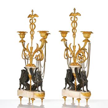 A pair of Louis XVI three lights Candelabra, Parisian works, in the manner of François Rémond, late 18th century.