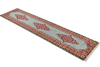 An oriental runner, c. 550 x 74 cm.
