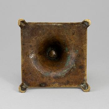 A 17th century bronze candlestick.