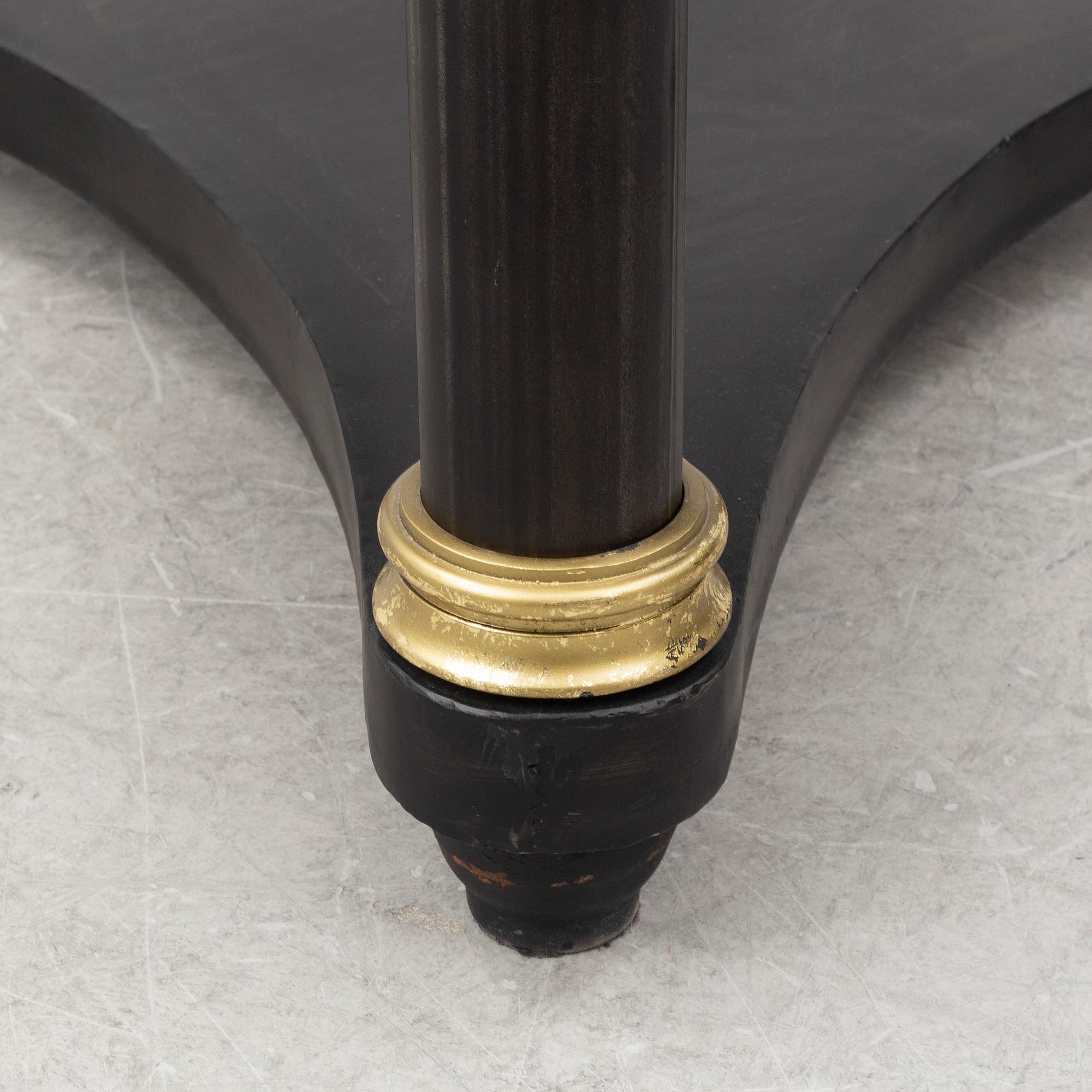 A contemporary empire style sheet metal center table.