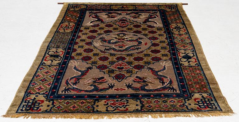 A Chinese silk and metal thread yellow ground 'five clawed dragon' carpet, Qing dynasty, 19th century. (Measure 208x126).