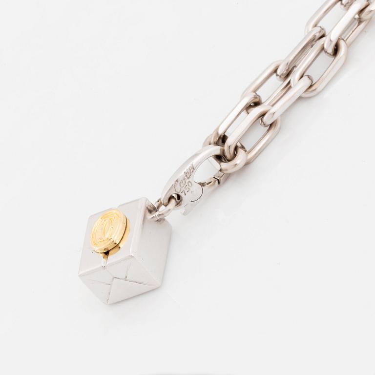 An 18K gold and white gold Cartier necklace with a charm.