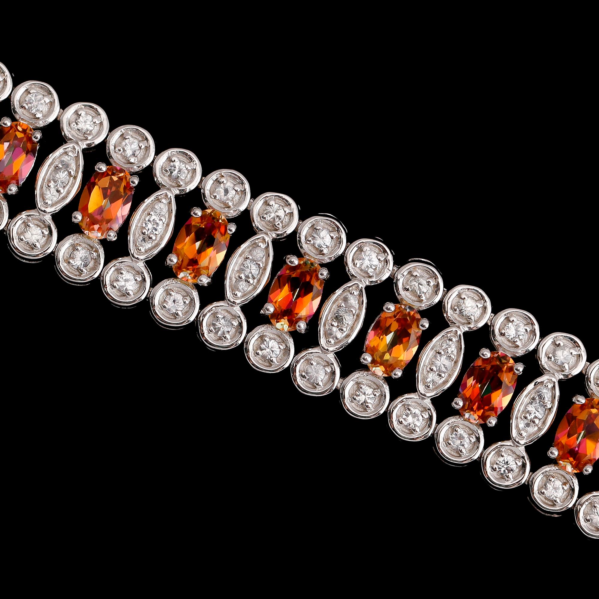 ARMBAND, sterlingsilver, vita och färgade topaser tot ca 17.00 ct.