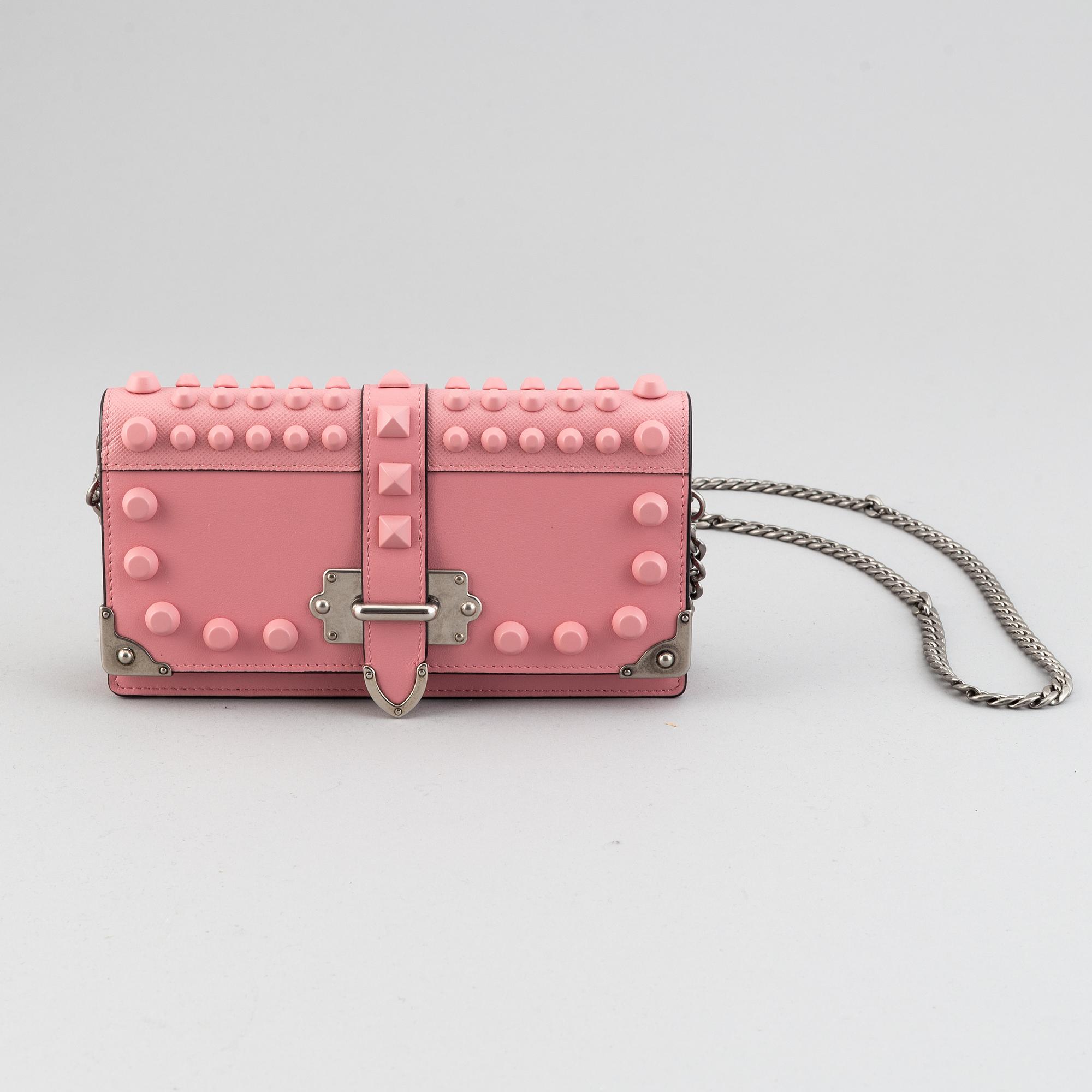 A Prada leather mini bag " Cahier" with metal details and rivets. Marked "Prada Milano". Authenticity card included.