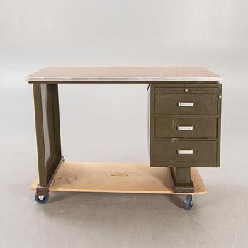 An 1950:s industrial metal and linoleum writing desk.