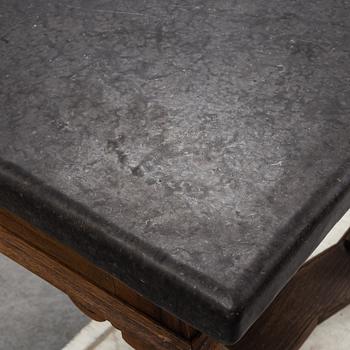 A 19th Century Baroque style table with a stone top.