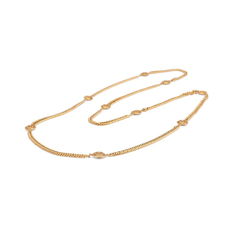 CHANEL, a gold colored medallion necklace.