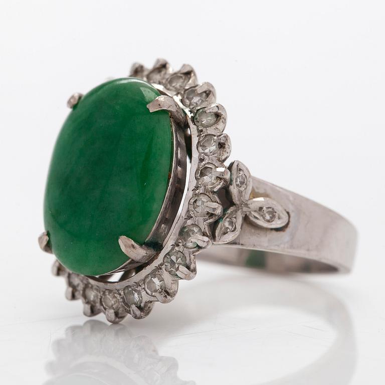A palladium-plated silver ring with cabochon-cut jadeite and diamonds.