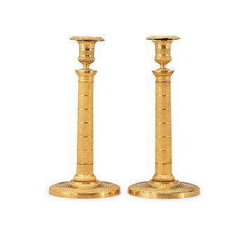 1627. A pair of French Empire early 19th century candlesticks.