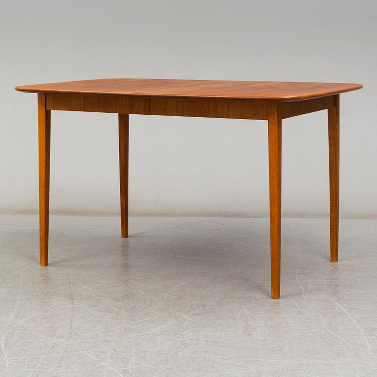 A late 20th Century teak veneered dinner table.