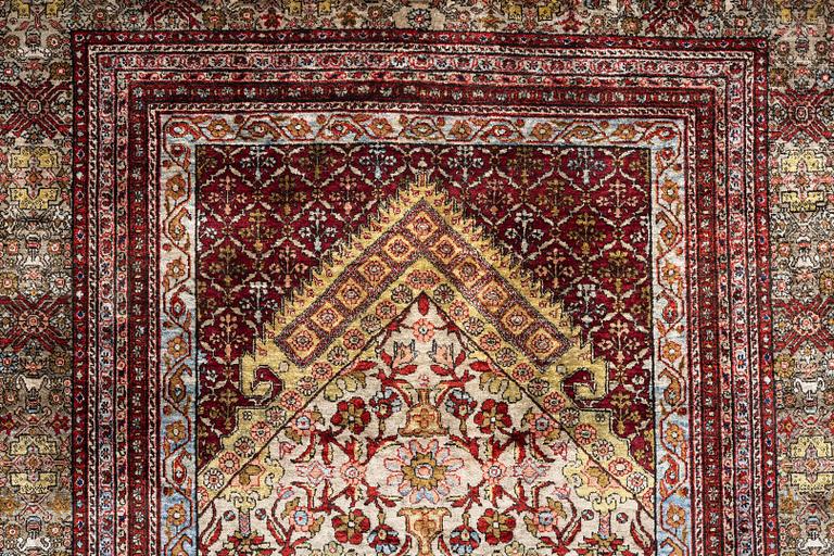 A semi-antique silk Qum rug, central Persia 221 x 138 cm.