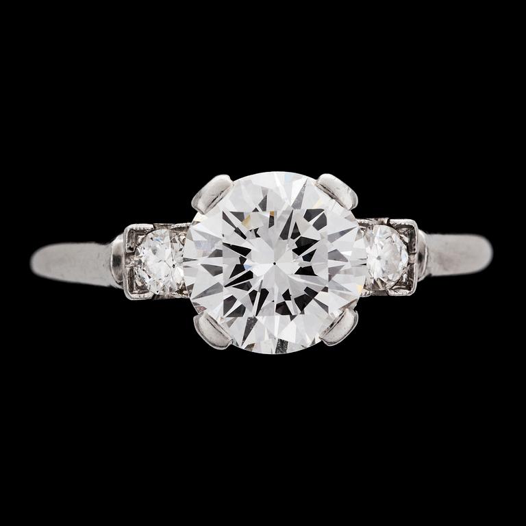 A brilliant cut diamond ring, app. 1.50 cts, set with two small diamonds.