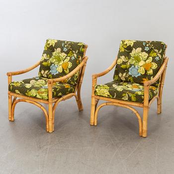 A set of ratten furniture, late 20th century; sofa, armchairs and a lounge table.