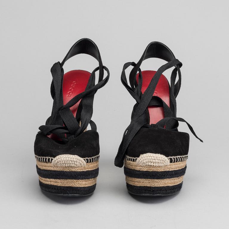 A pair of Gucci wedge shoes size 36.