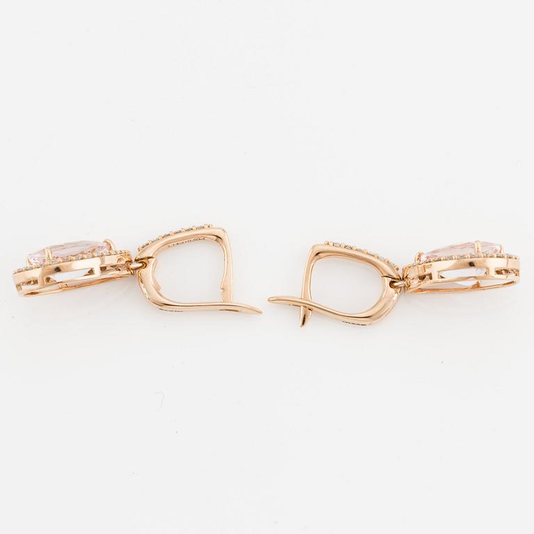 A pair of 18K gold earrings with faceted morganites and round brilliant-cut diamonds.