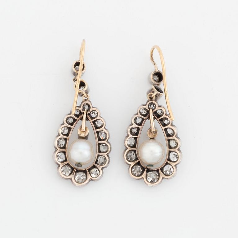 A pair of silver and gold earrings set with old-cut diamonds and pearls.