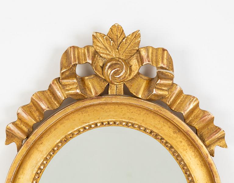 A pair of Gustavian style two-light giltwood girandole mirrors, 20th century.