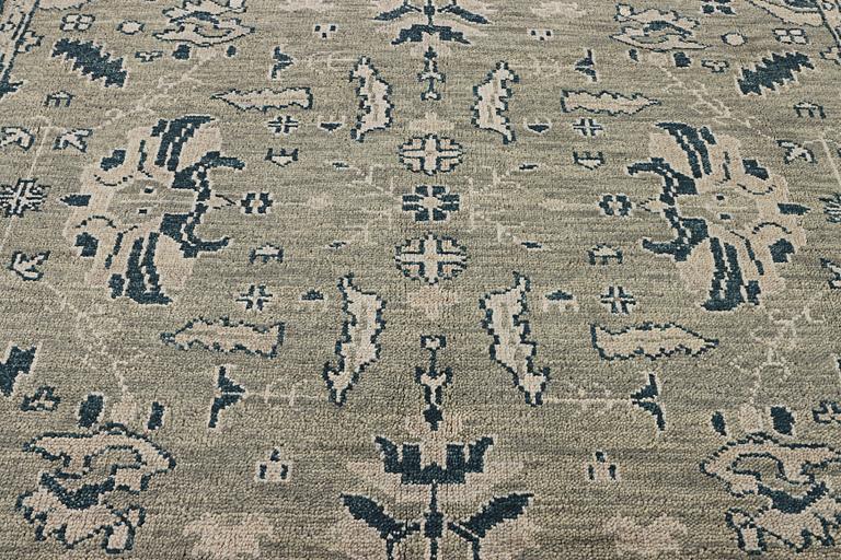 An oriental carpet with Mamluk design, c. 372 x 277 cm.