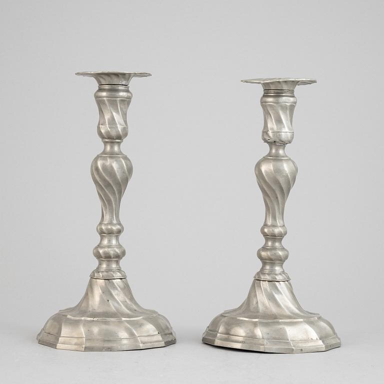 A pair of rococo style pewter candlesticks, 19th Century.