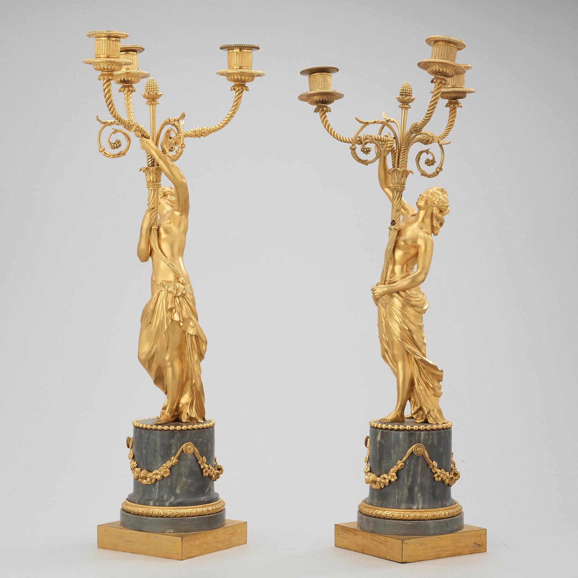 A pair of Louis XVI circa 1780 three-light gilt bronze and bleu turquin marble candelabra.